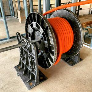 Rack-A-Tiers wire dispenser dispensing a large wire reel.